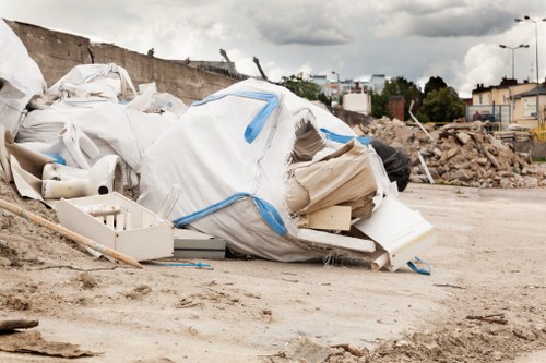 Company van and crew preparing a skip